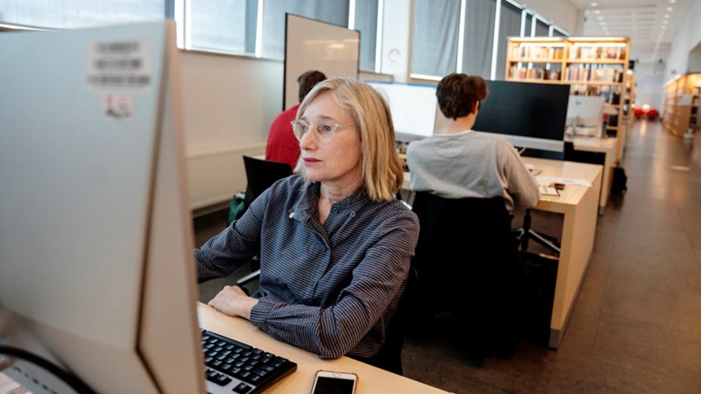 A student sits in front of a computer.