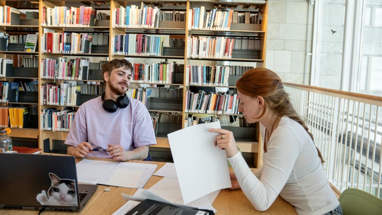 Two students at a desk.