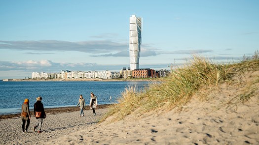 People walking by the beach in Malmö.