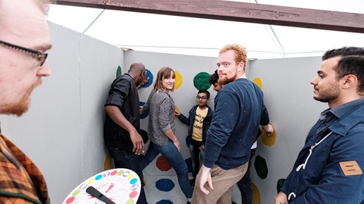 Students playing a game with their bodies and coloured circles.