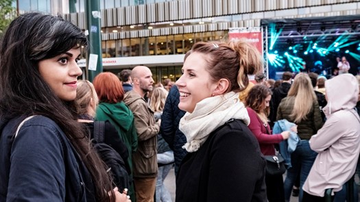 Students smiling in a crowd