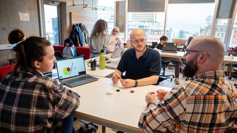 Three students sitting at a table